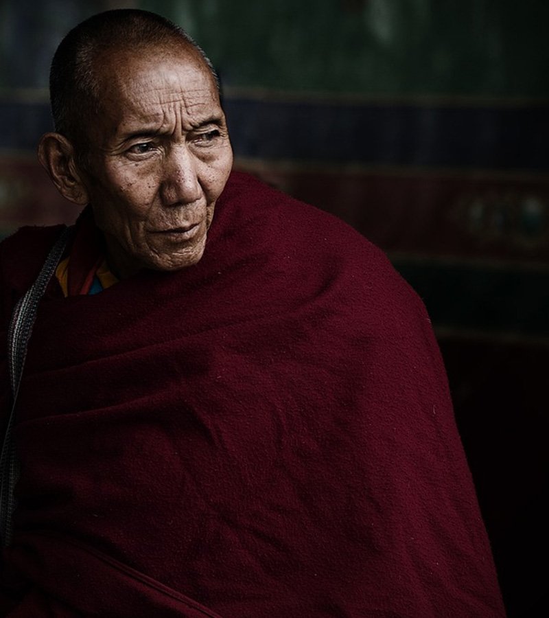 Portrait of a person wearing a burgundy robe